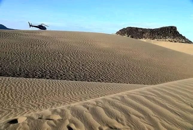Helicopter over the sand dunes of Suguta Valley